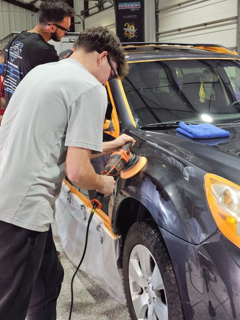 Machine polishing an SUV fender at Detailing Success training, Blue Badge Customs mobile detailing in Lawrence, Kansas