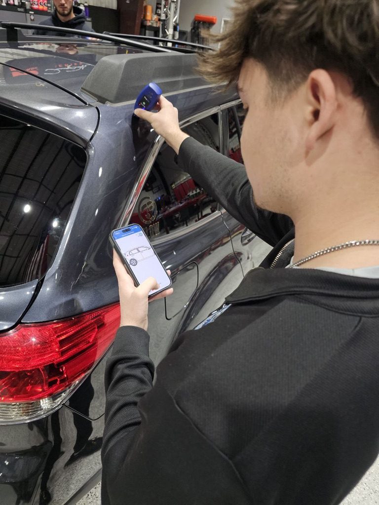 Measuring paint thickness with a paint depth gauge at Detailing Success training, Blue Badge Customs mobile detailing in Lawrence, Kansas